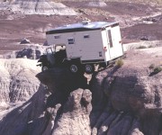A historical photo of a 1969 CJ5 Jeep Camper parked on a cliff edge at Petrified Forest.