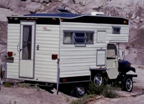 Close-up view of the CJ5 Camper against the scenic backdrop of Petrified Forest.